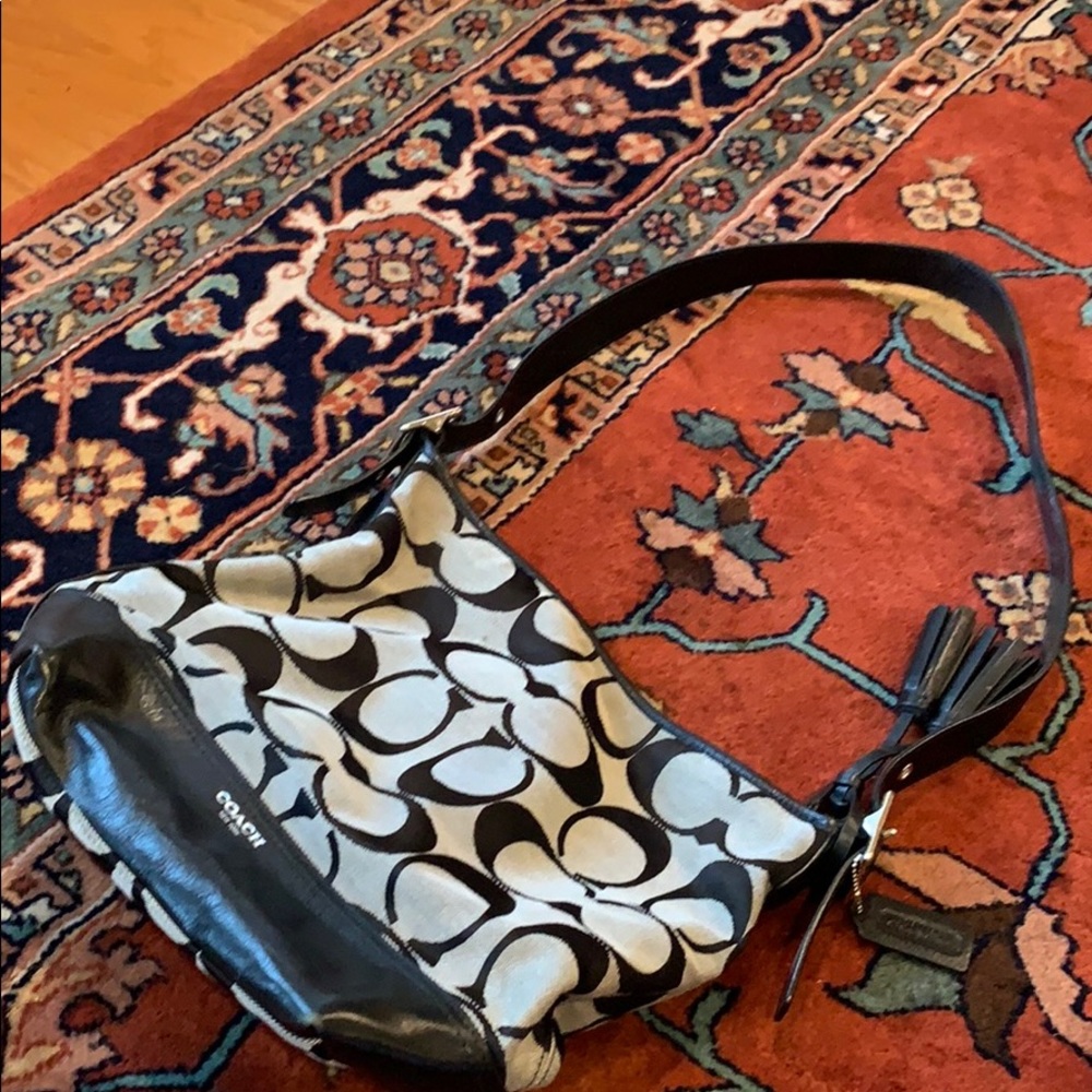 Signature black Coach crossbody bucket bag.